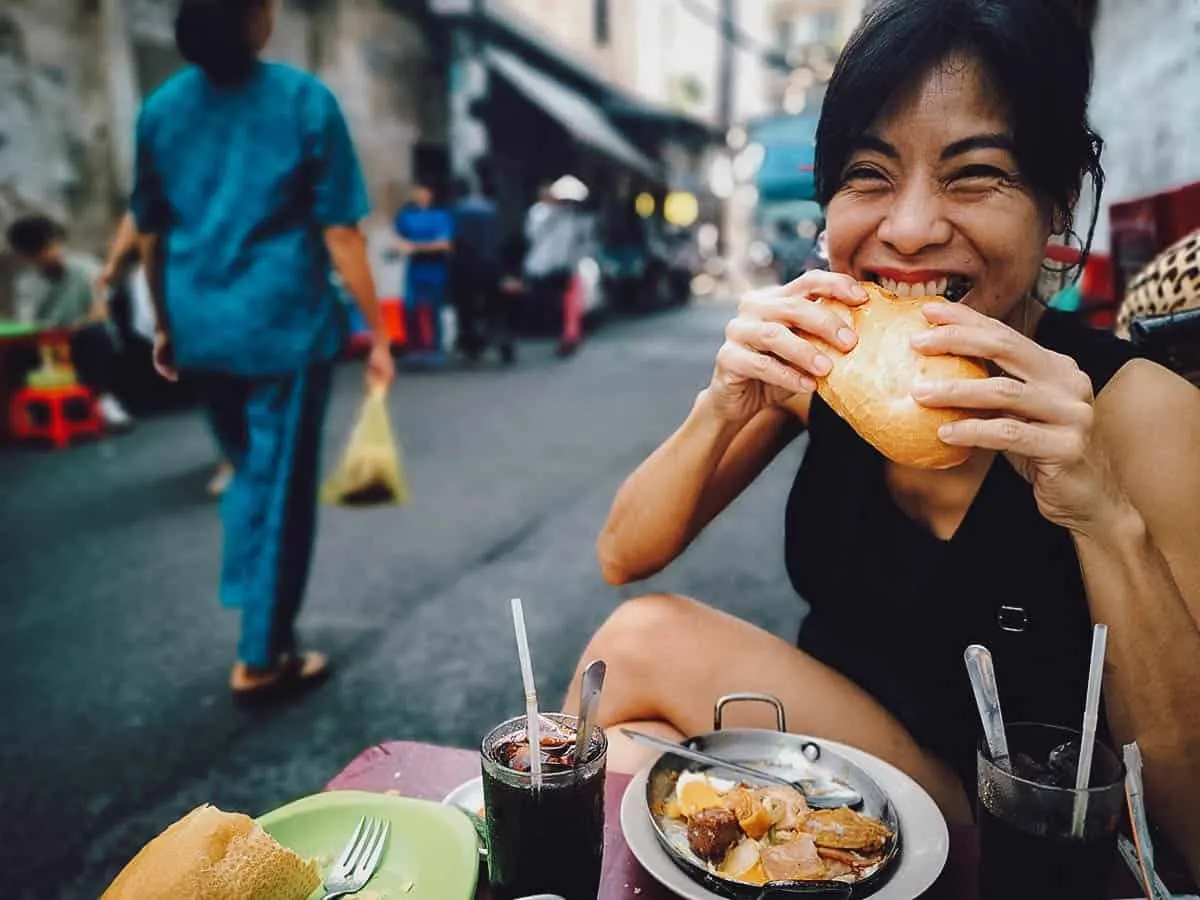 Ren eating banh mi in Ho Ch Minh City