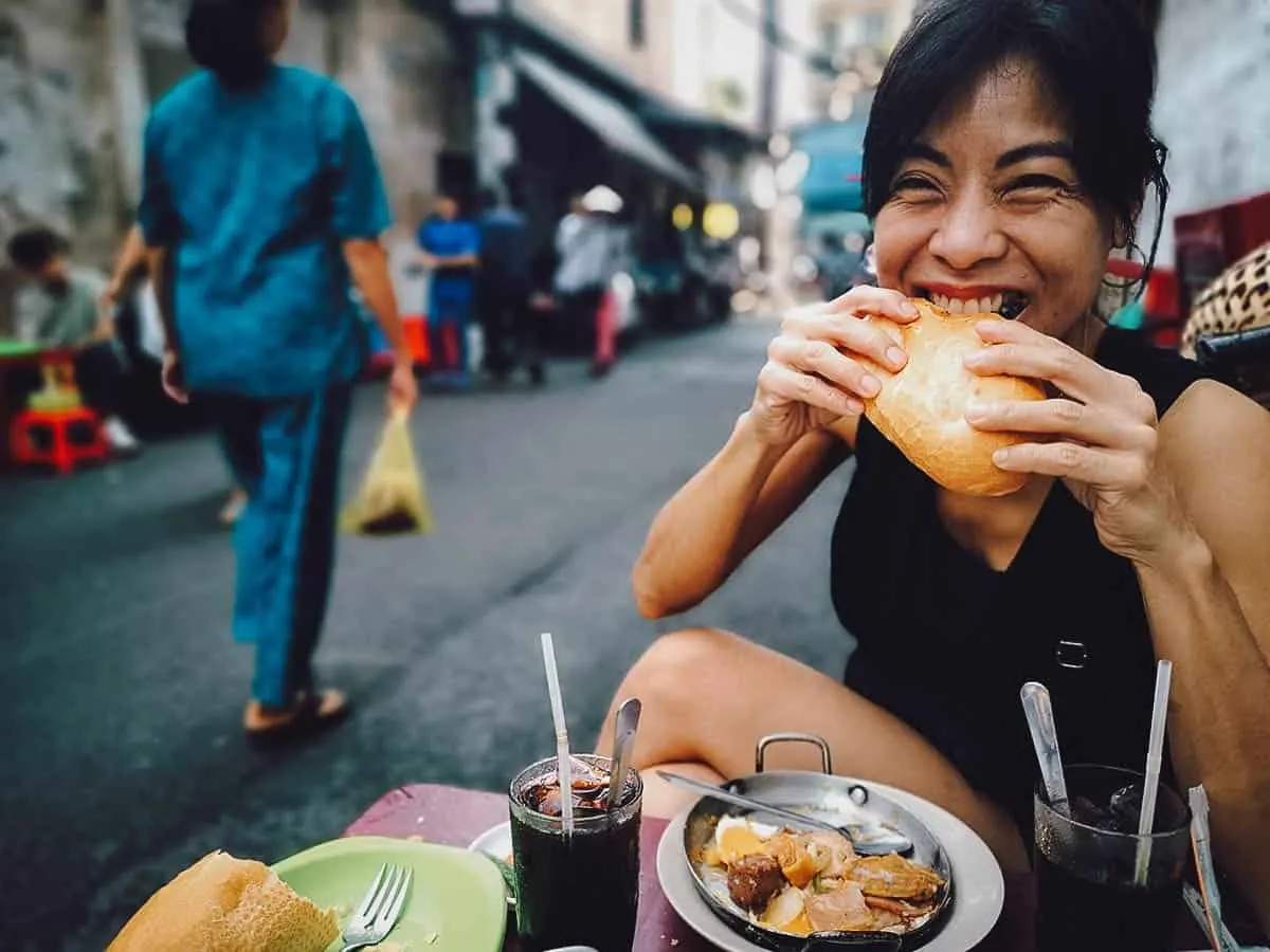 Ren biting into banh mi