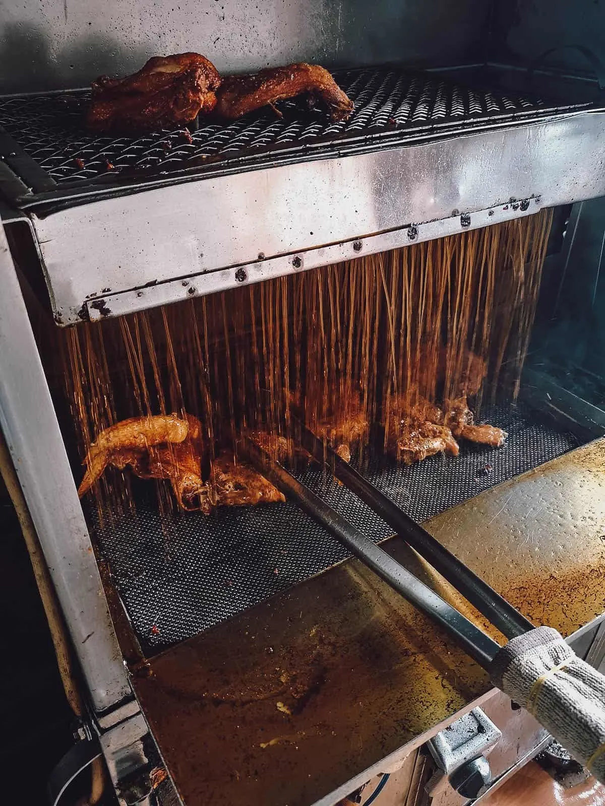 Chicken frying machine at Com Ga Xoi Mo Su Su restaurant in Saigon