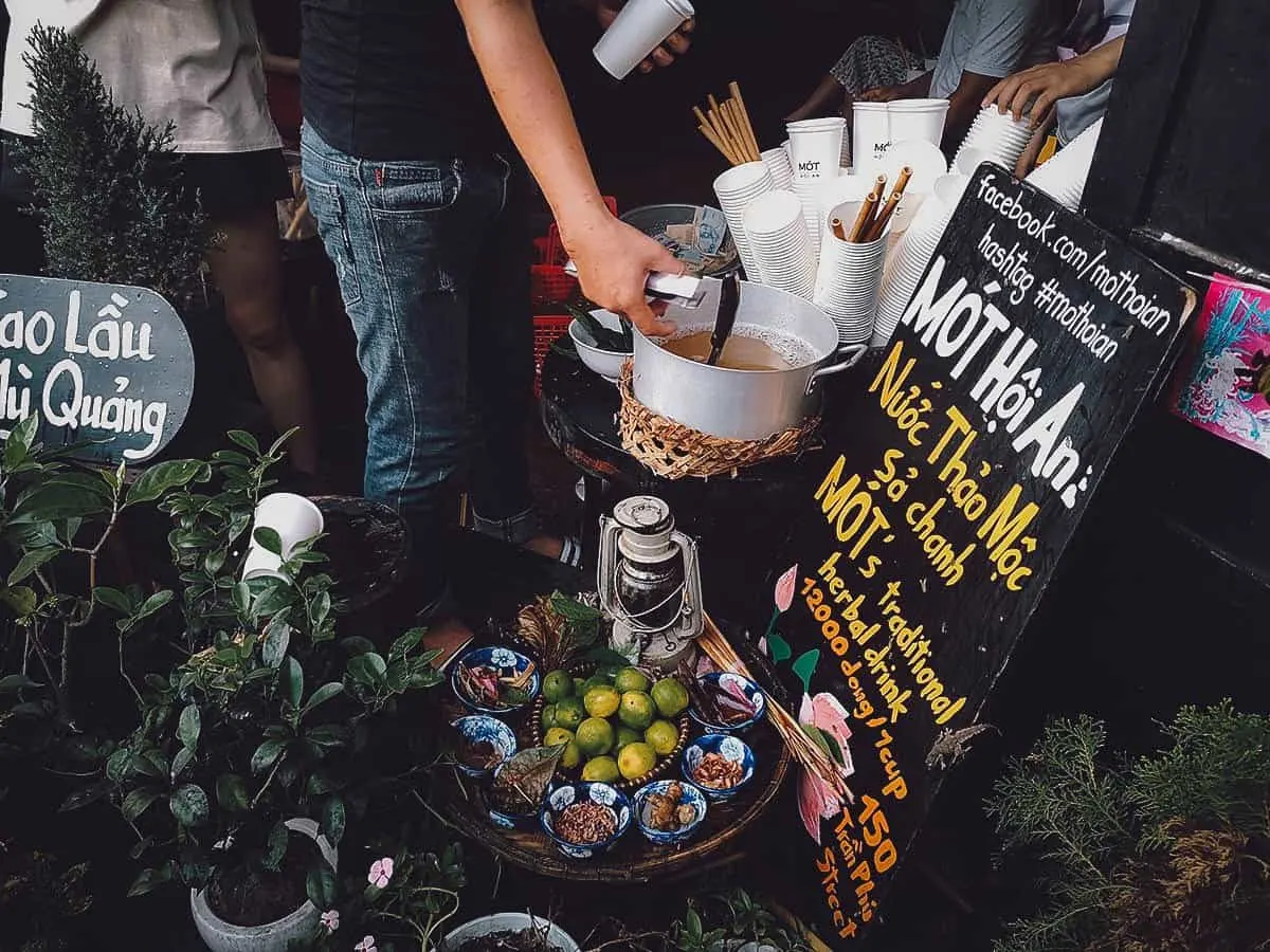 Man pouring herbal tea at Mot in Hoi An, Vietnam