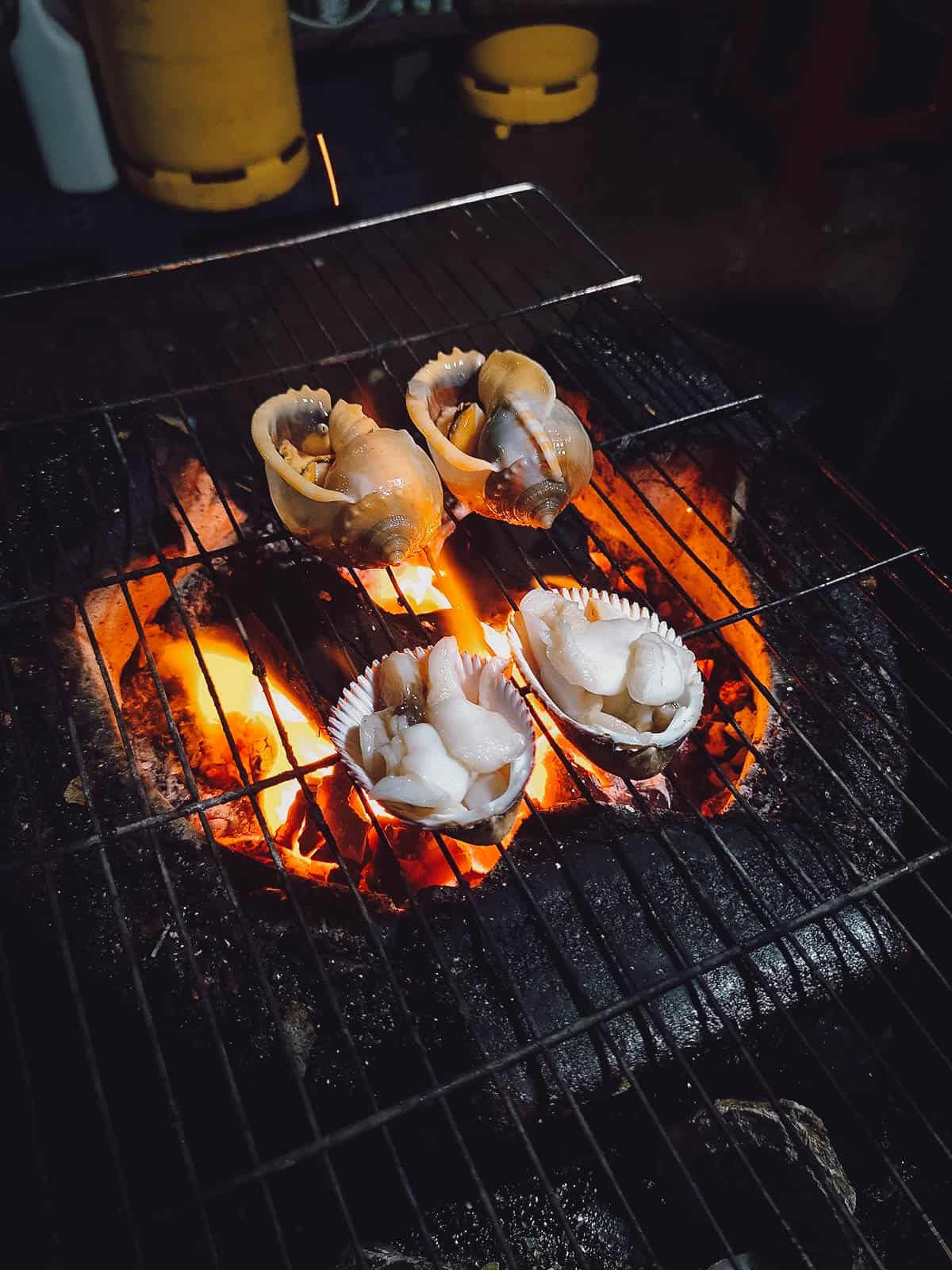 Grilling snails at Oc Loan in Saigon