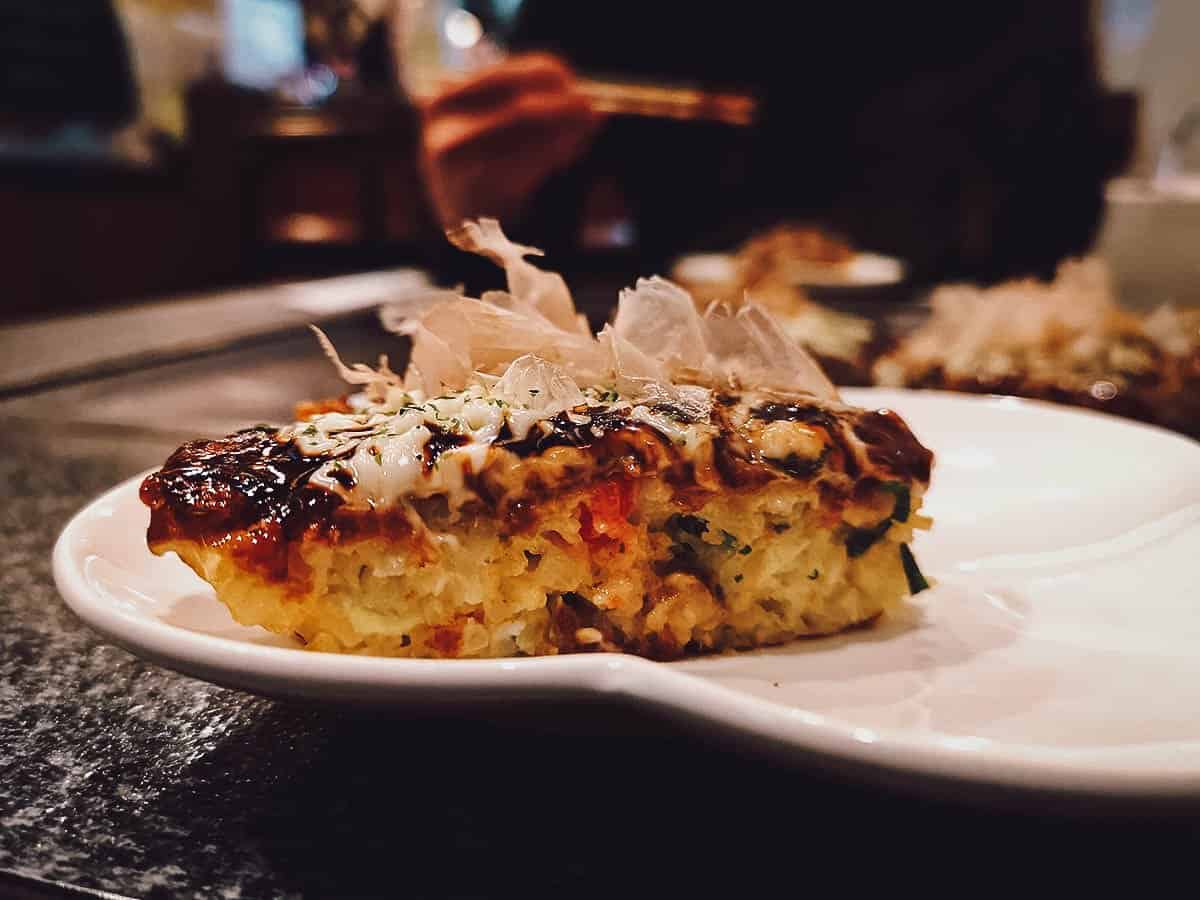 Slice of okonomiyaki at Fue restaurant in Osaka