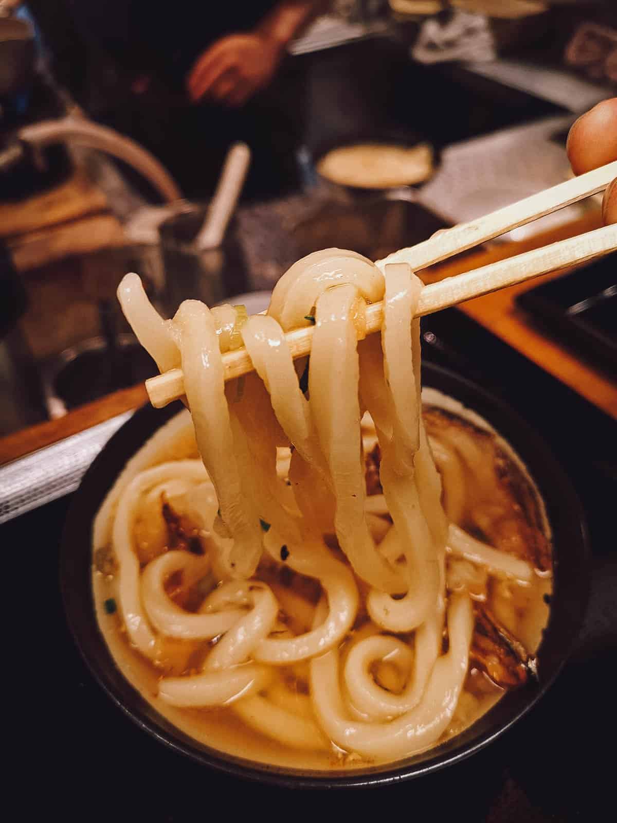 Udon with tempura scraps, a Japanese noodle soup dish made with thick wheat noodles