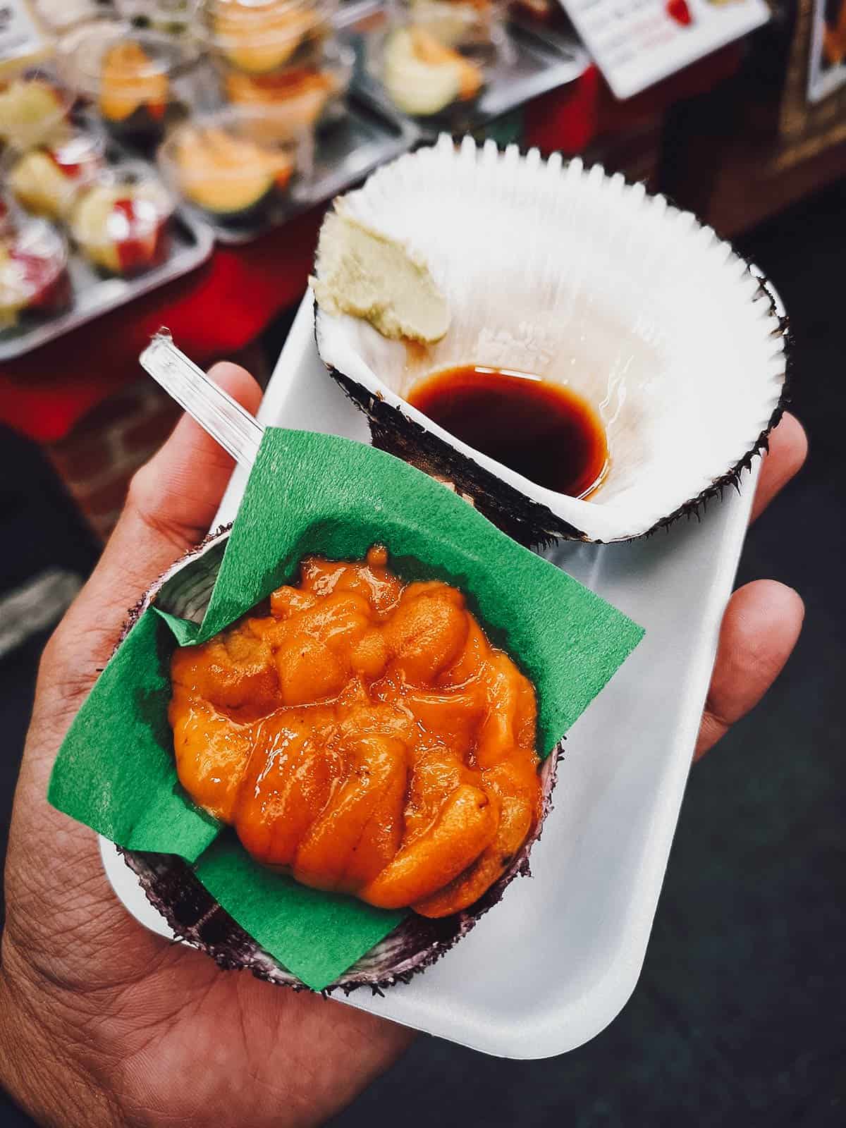 Uni or sea urchin sashimi in a shell with soy sauce and wasabi