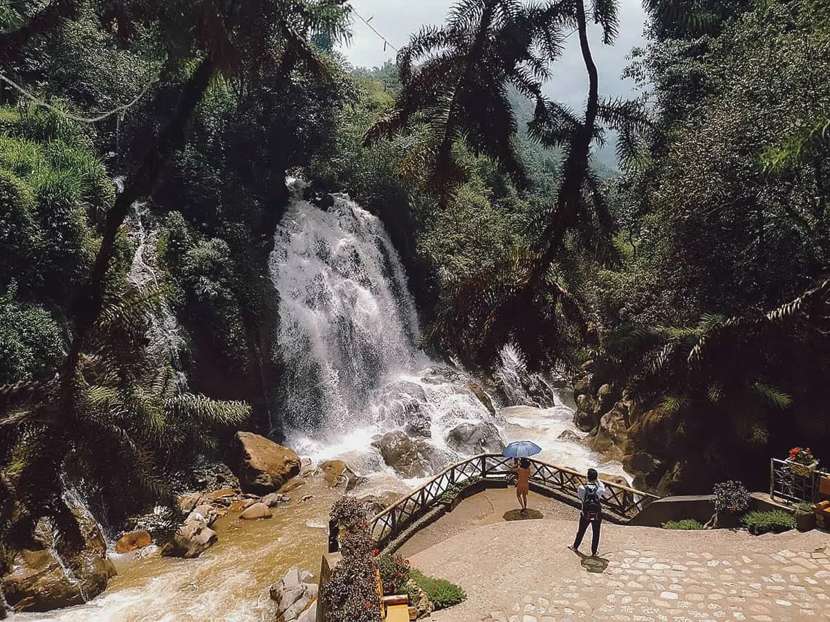 Cat Cat Waterfall in Sapa, Vietnam Couple taking photos in front of Cat Cat Waterfall