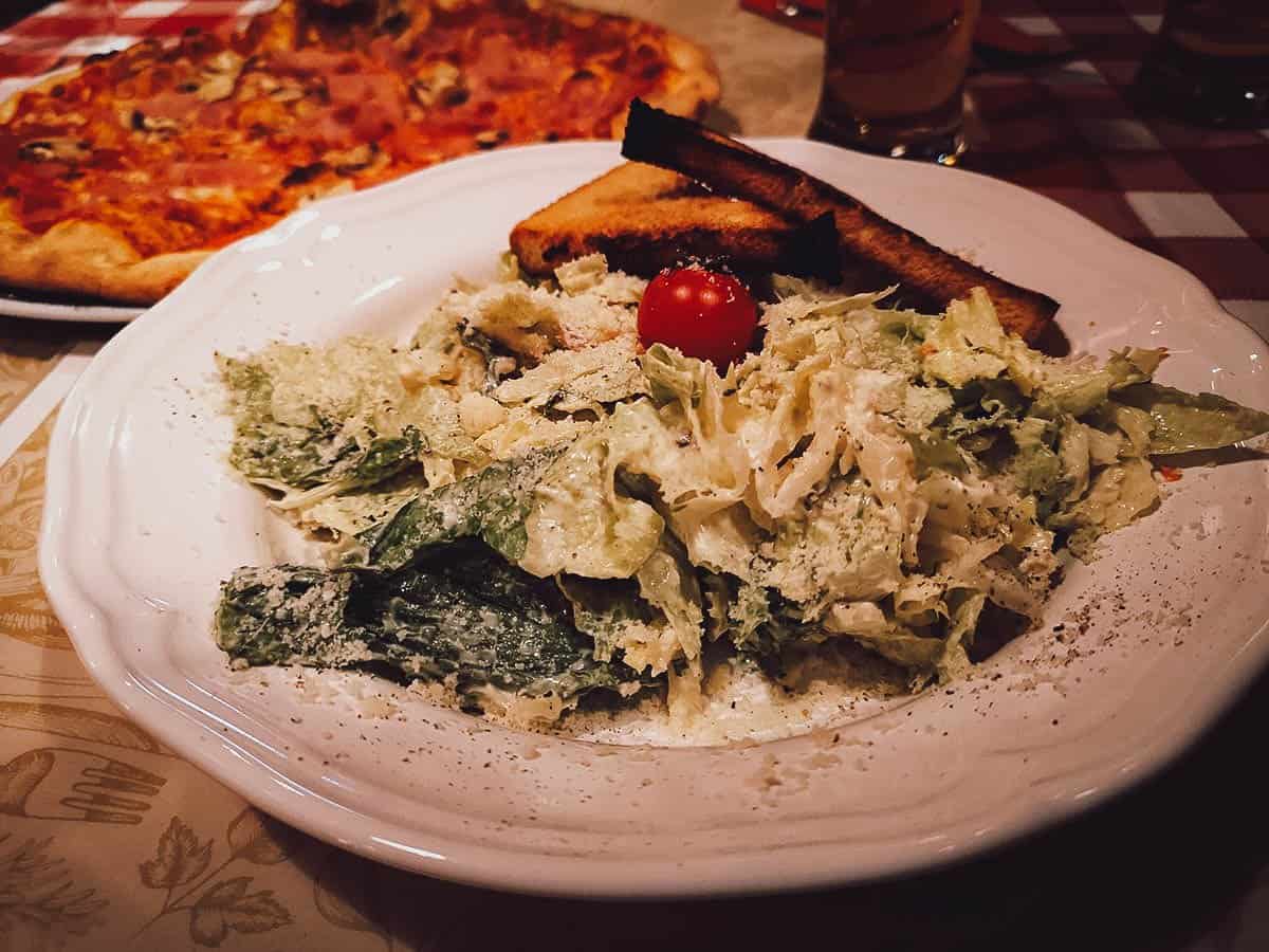Salad, pizza, and side dishes at Il Buco in Budapest, Hungary