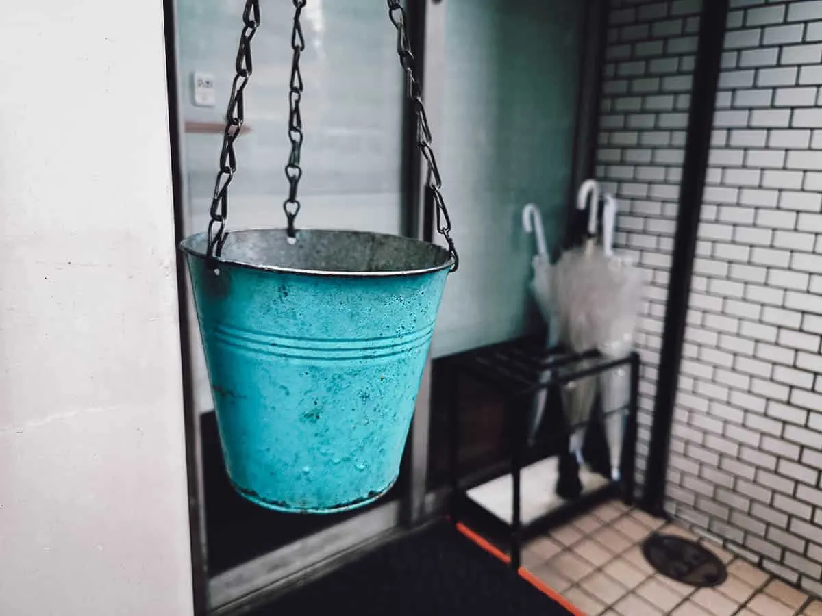 Blue bucket hanging outside Hakata Genki Ippai exterior in Fukuoka