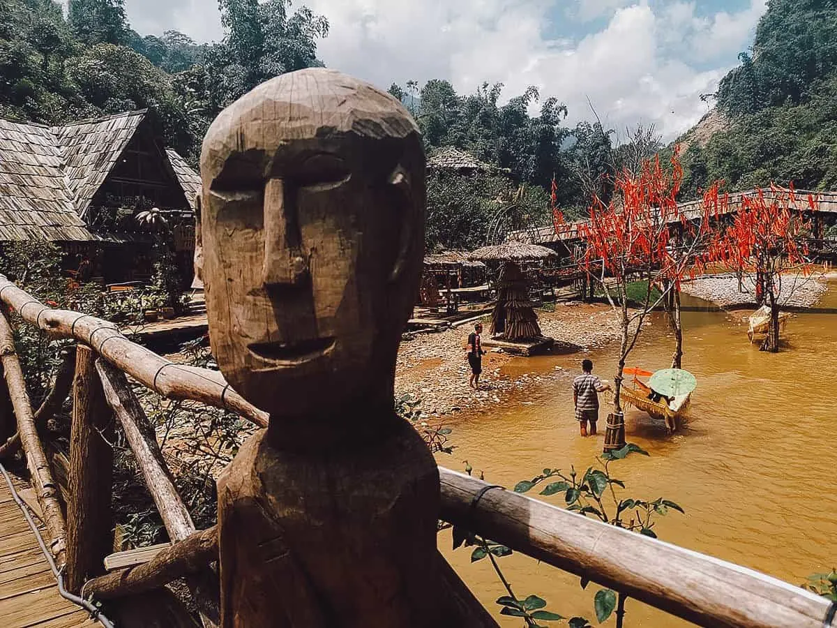 Cat Cat Village in Sapa, Vietnam Wooden statue on bridge in Cat Cat Village