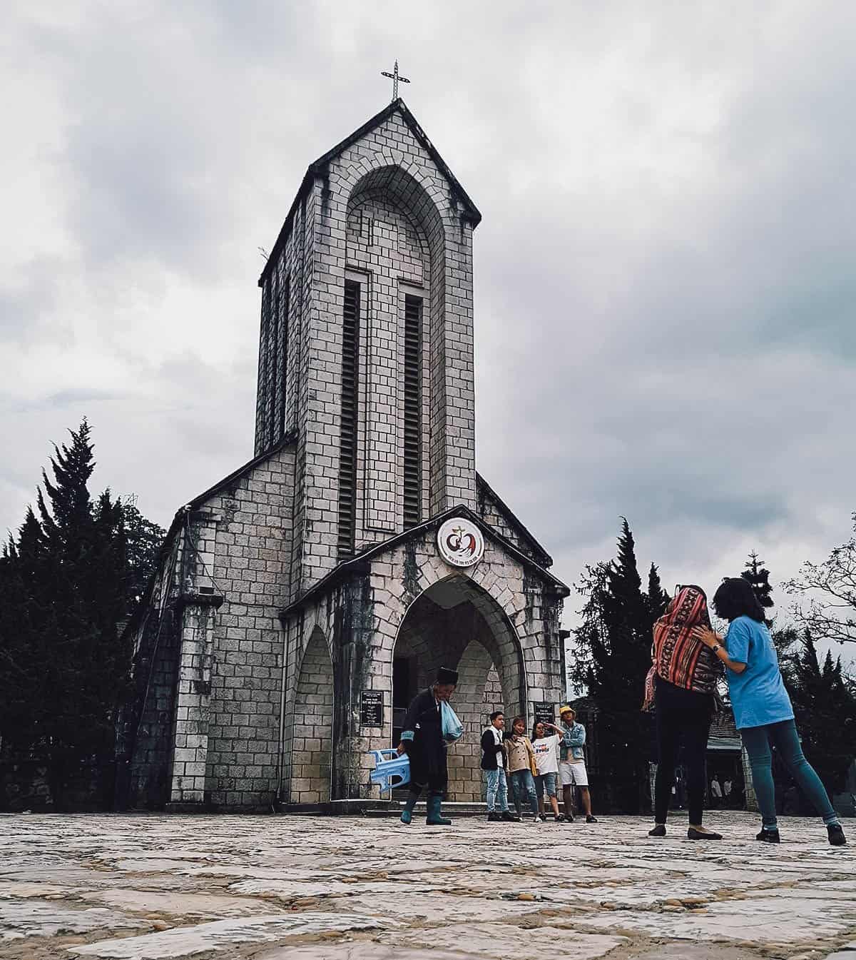 People taking photos in front of Holy Rosary Church