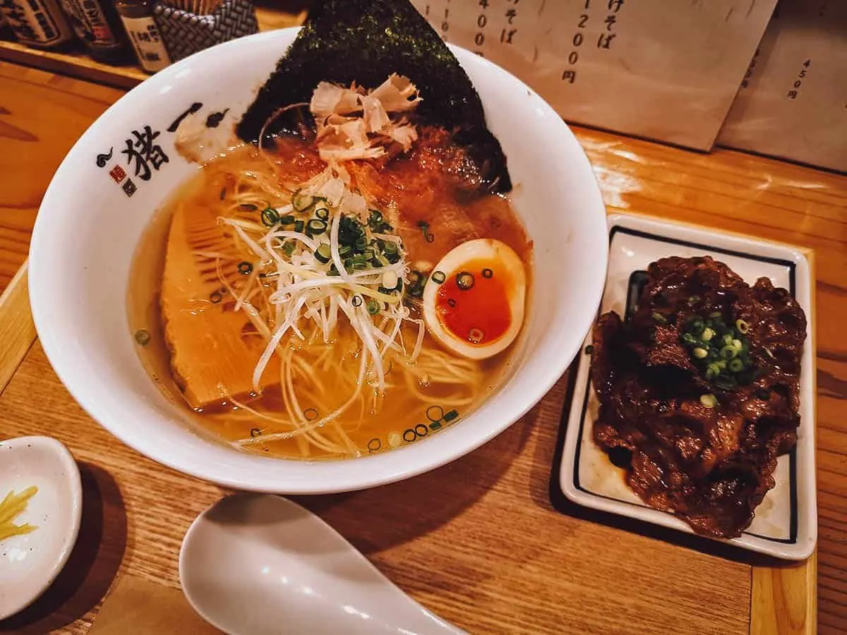 Bowl of ramen with a side of beef at a restaurant in Kyoto