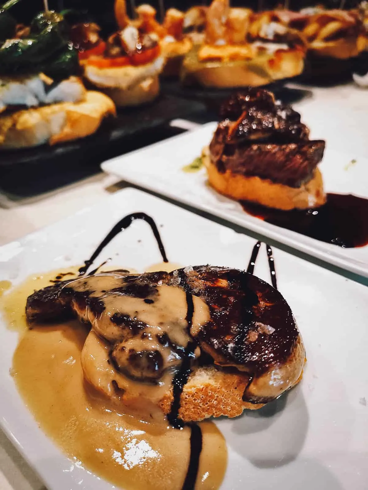 Spanish Food Guide: 45 Dishes to Eat in Spain Pintxos with foie gras, one of the most delicious Spanish dishes from the Basque Country