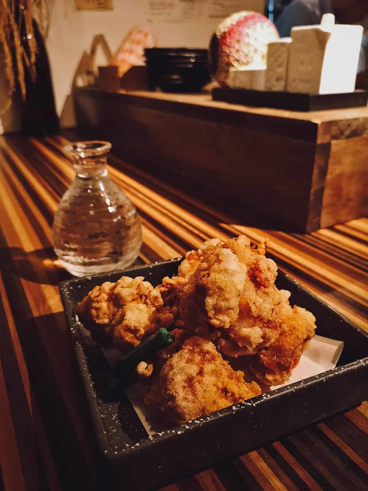 Vial of sake with an appetizer at a restaurant in Kyoto