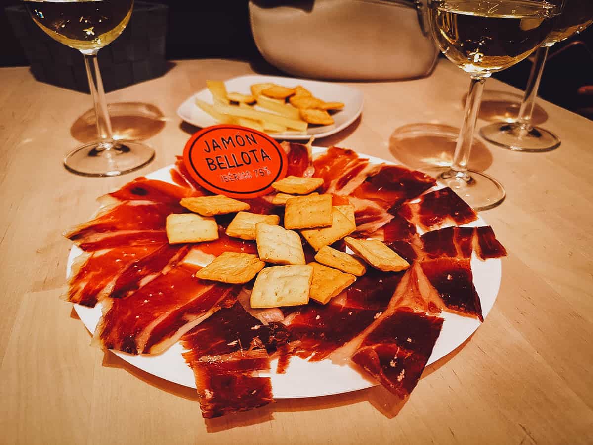 Jamon Iberico de Bellota with white and red wine, one of the best meat dishes in Spain