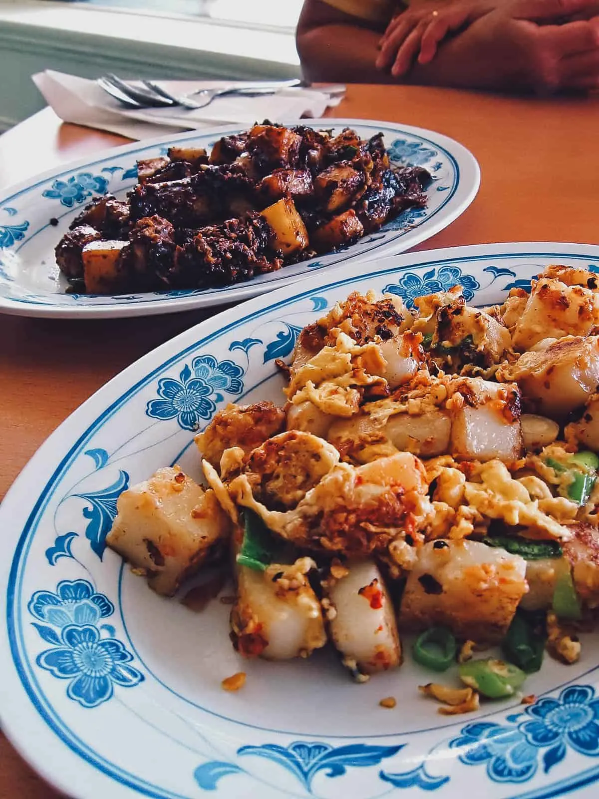 Plates of dark and light chai tow kway in Singapore