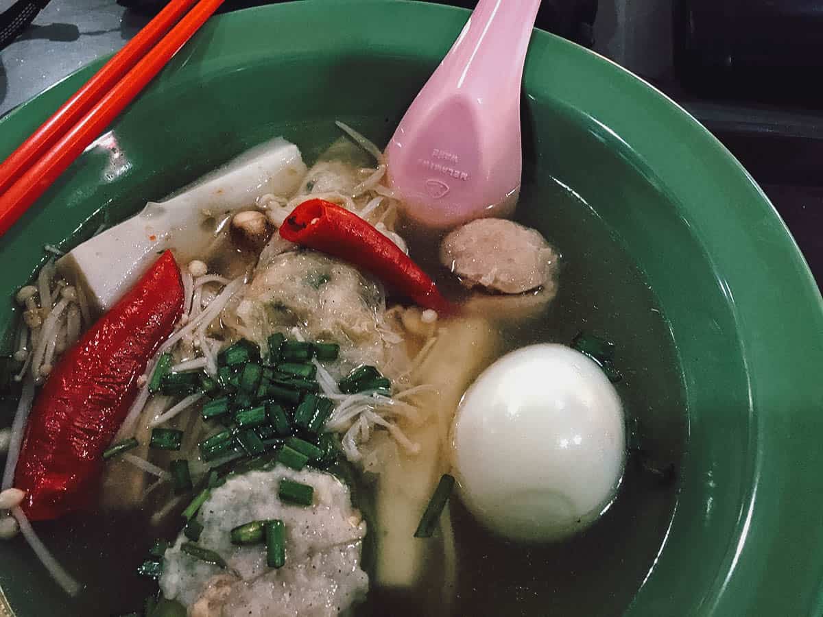 Bowl of yong tau foo with fish balls, fish cake, and hard-boiled eggs in Singapore