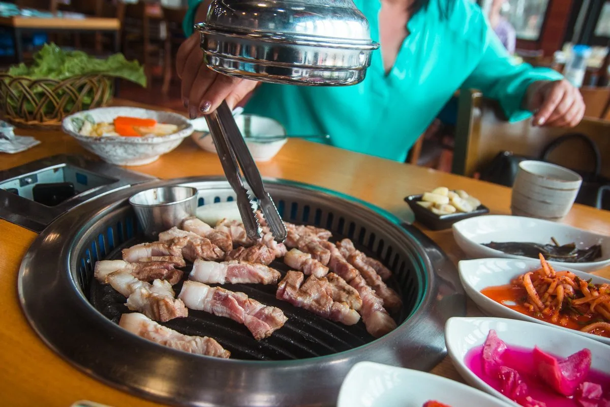 Woman grilling Jeju black pork