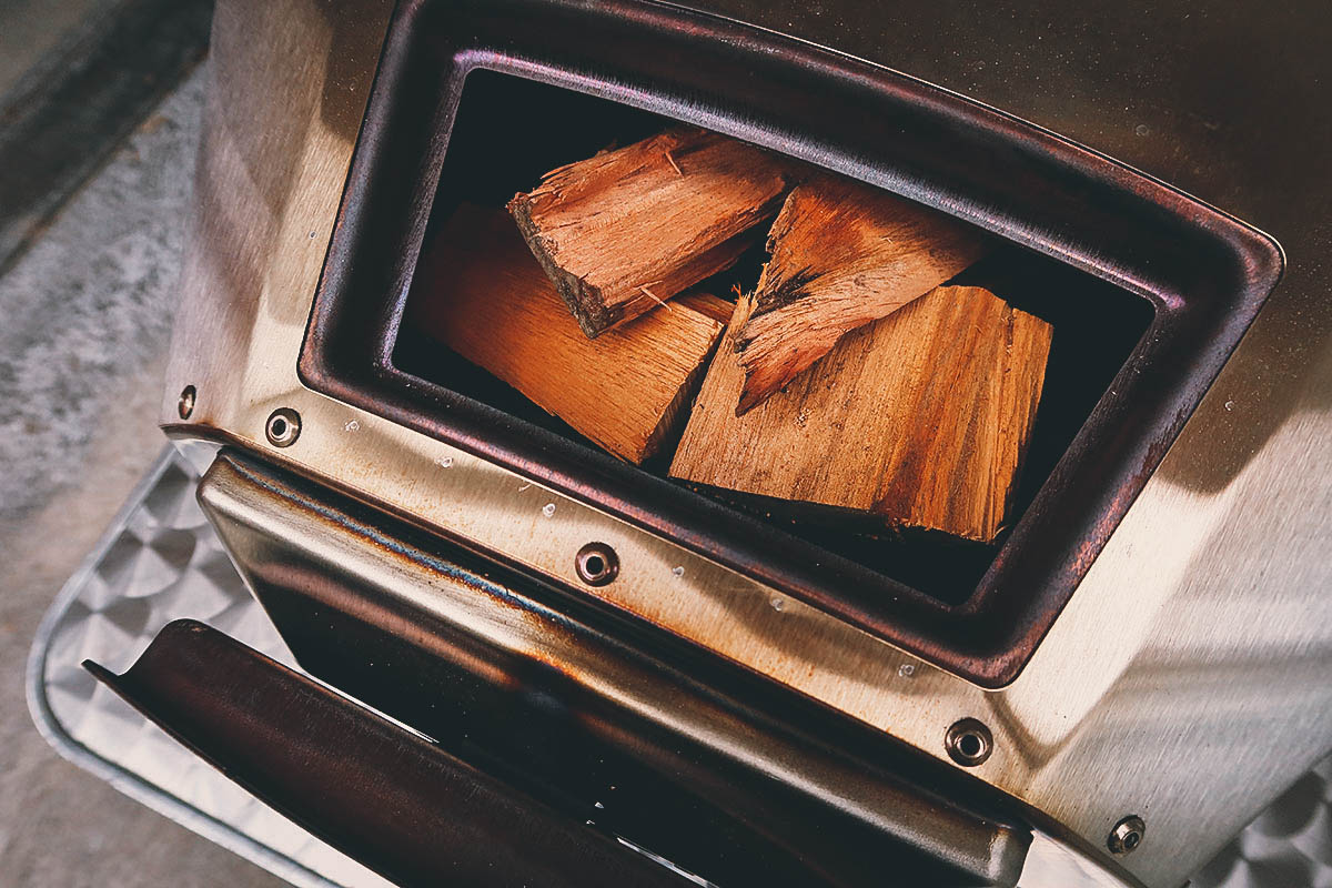 Ooni pizza oven tray loaded with firewood