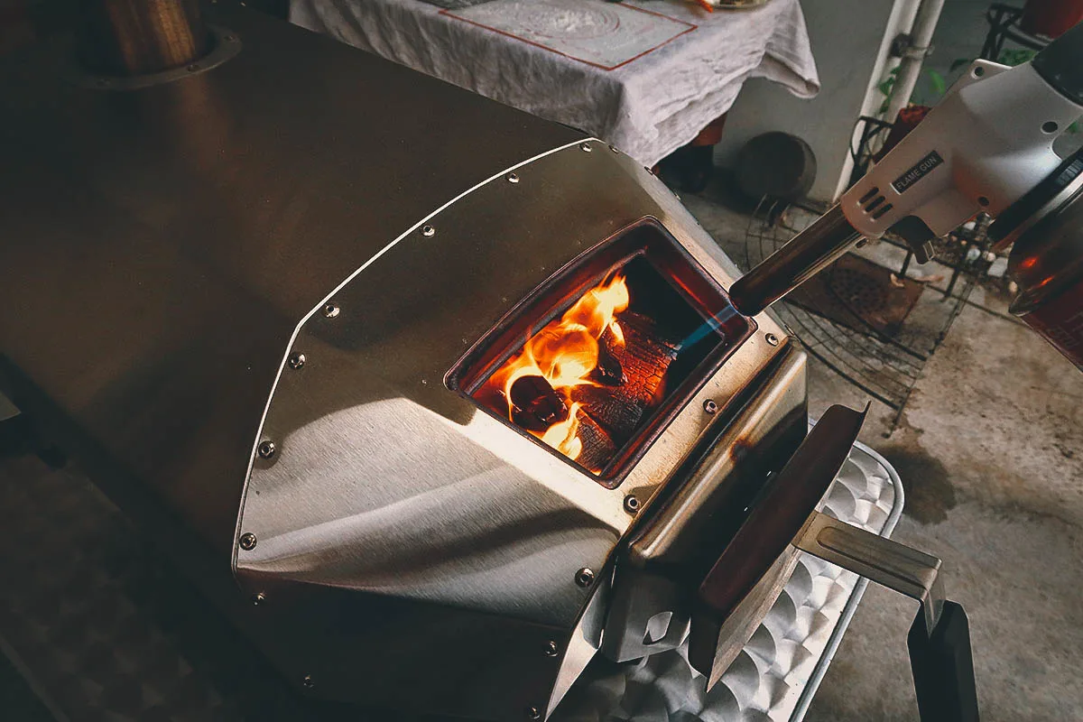 Lighting the firewood with a butane torch