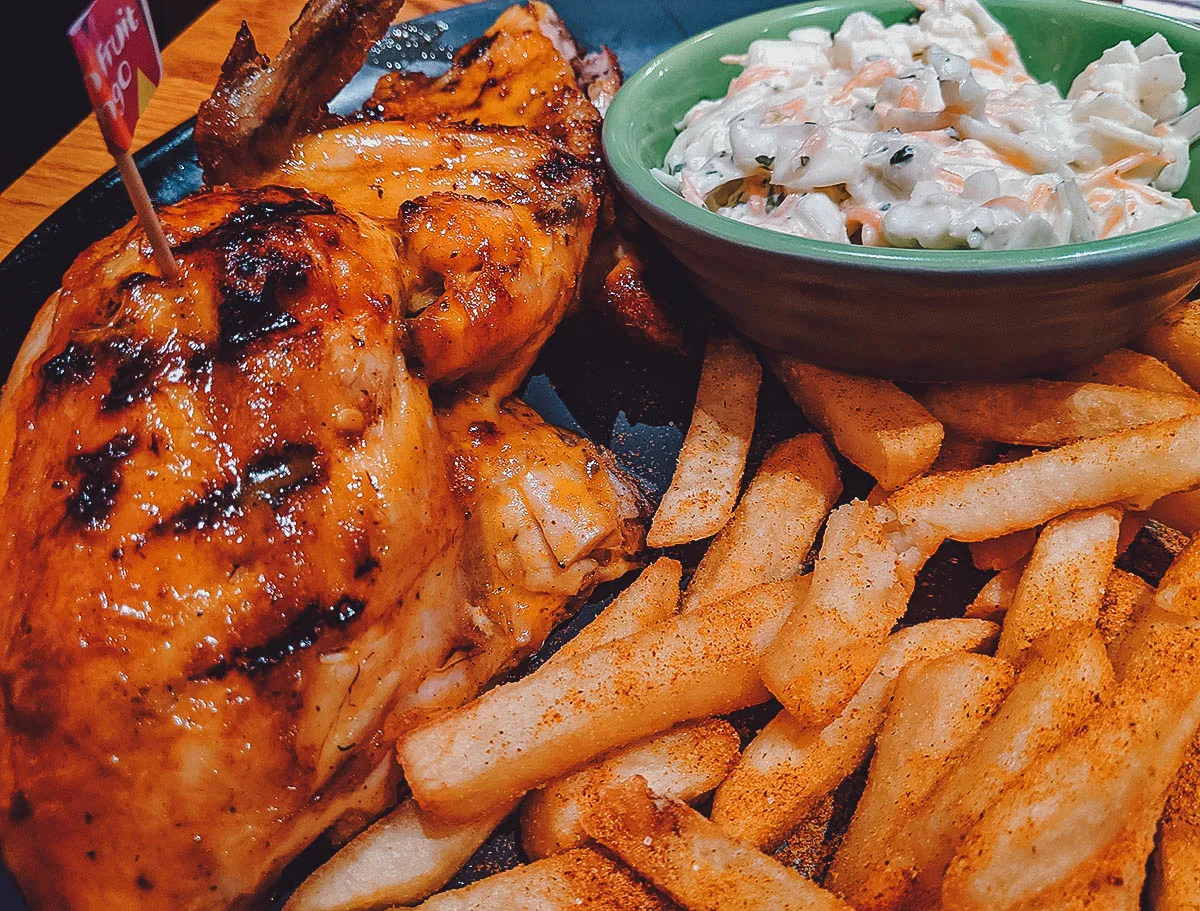 Peri Peri chicken, fries, and coleslaw