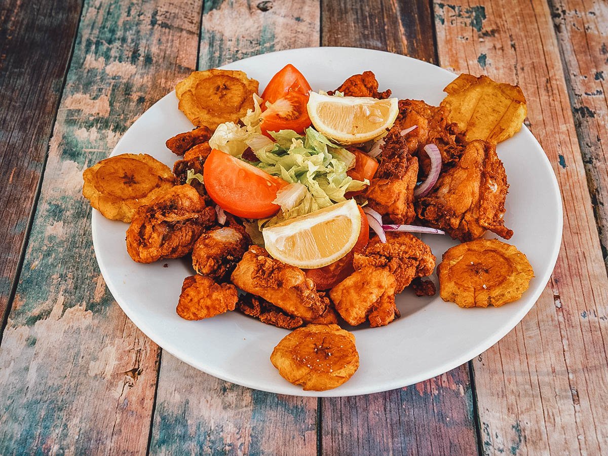 Pica pollo or Dominican fried chicken with tostones and salad