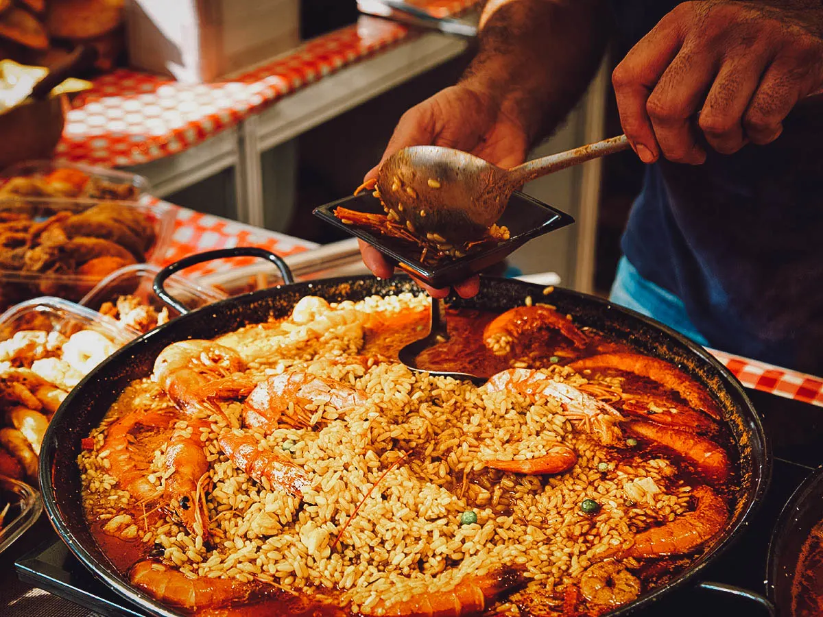 Madrid Travel Guide in Photos: Man serving paella at a mercado in Madrid, Spain