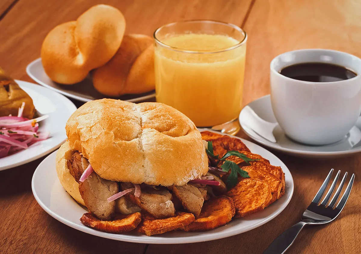 Pan con chicharron, a Peruvian sandwich made with fried pork