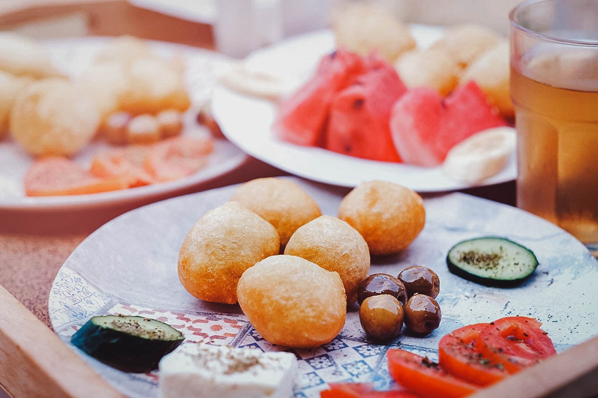 Plate of petulla or Albanian fried dough with olives, cheese, and tomatoes