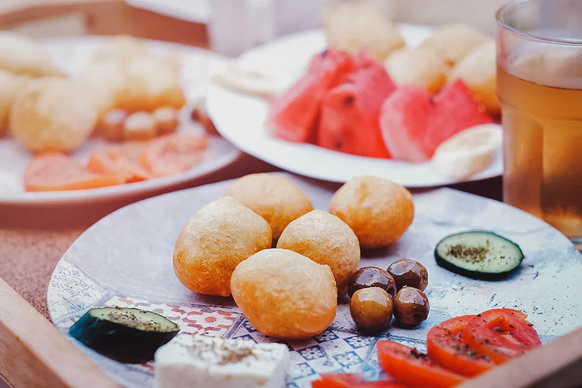 Guatemalan Food Plate of petulla or Albanian fried dough with olives, cheese, and tomatoes
