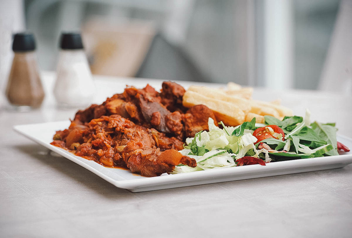 Stuffat tal-fenek or Maltese rabbit stew with a salad