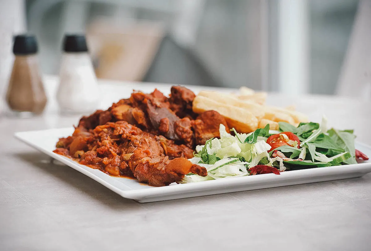 Maltese Food Stuffat tal-fenek or Maltese rabbit stew with a salad