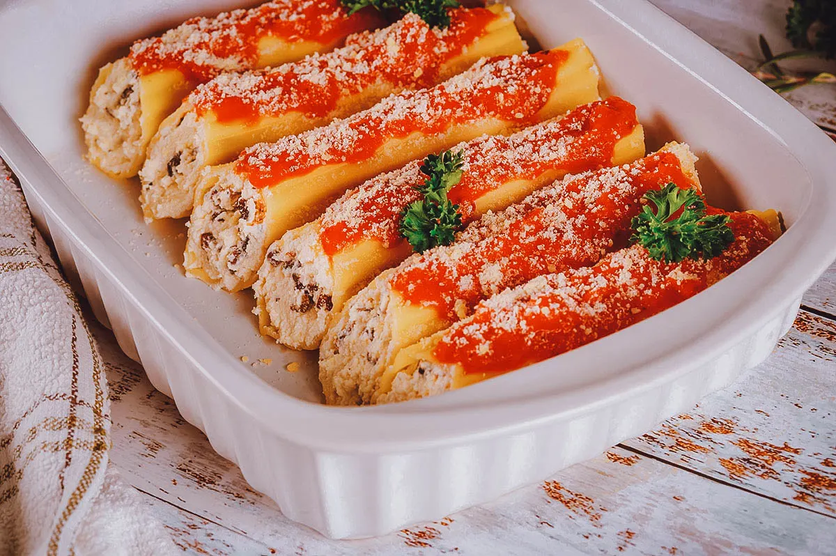 Argentinian Food Platter of canelones topped with cheese and sauce, the Argentinian version of cannelloni