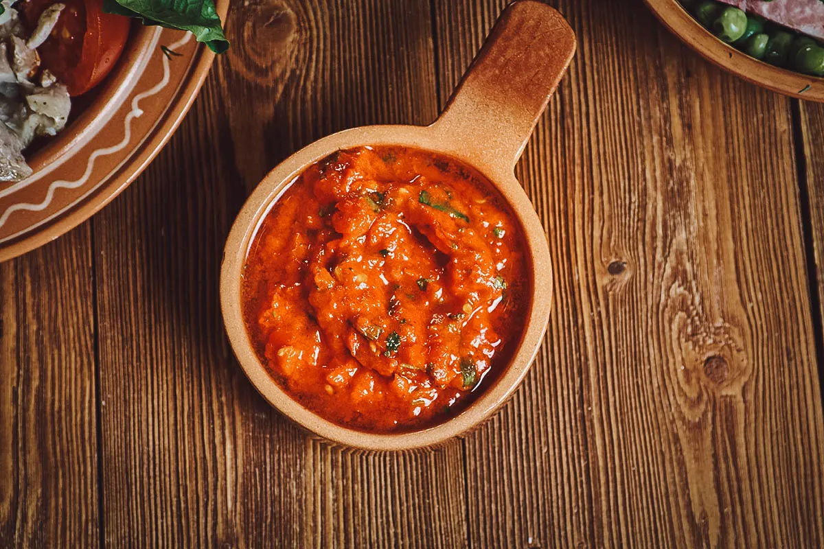 Chimichurri rojo, a popular Argentine condiment made with paprika, olive oil, chopped parsley, and other ingredients