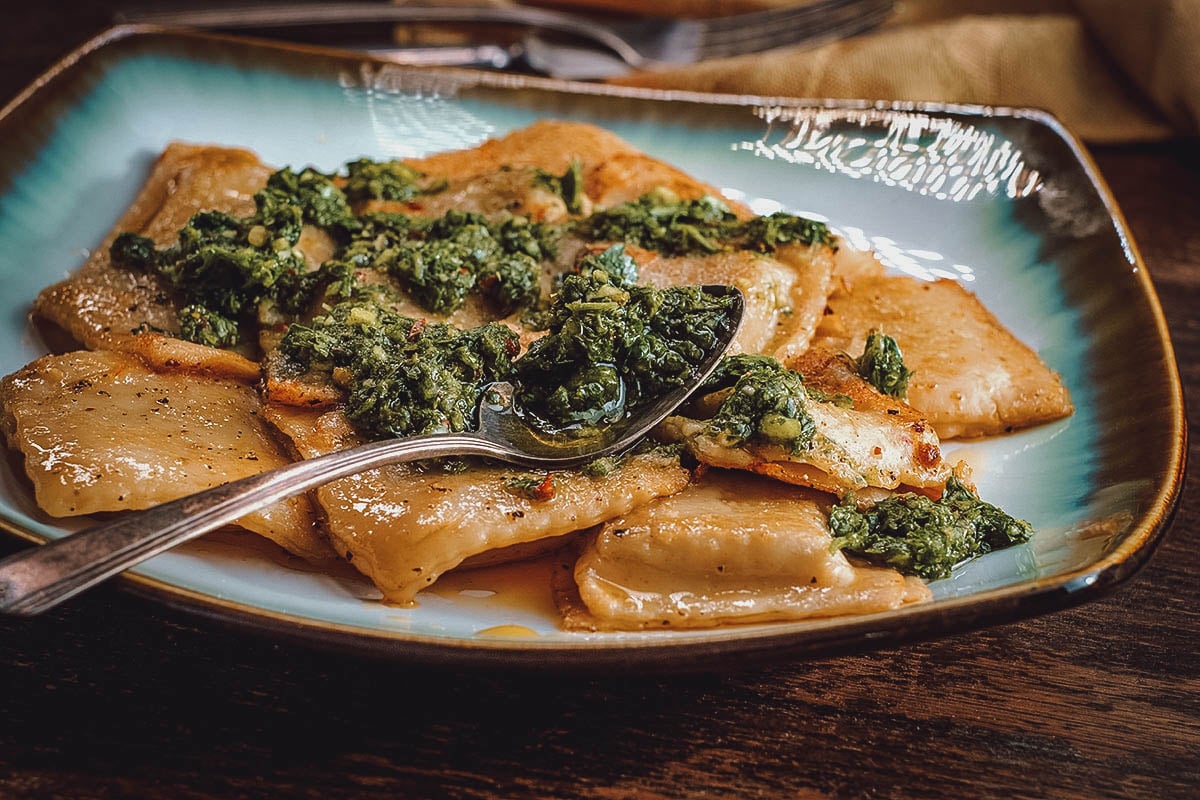 Plate of ravioles with chimichurri and olive oil