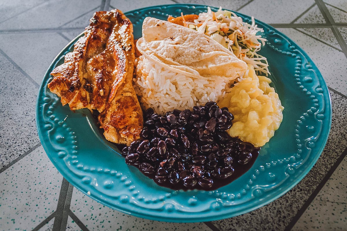 Plate of casado with black beans, one of the most popular dishes in Costa Rica