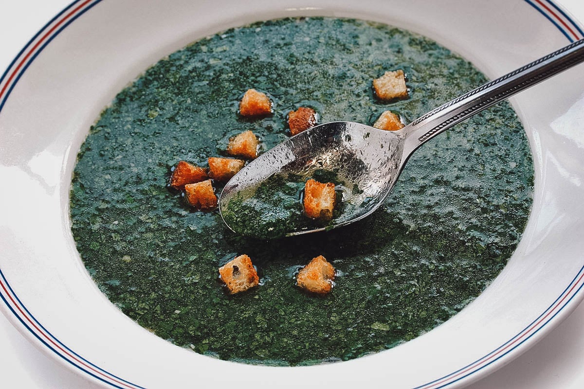 Close-up of mulukhiya, an Egyptian soup made with jute leaves in chicken broth