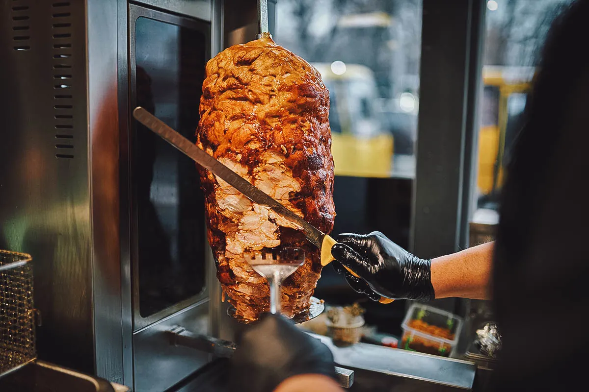 Shaving meat off a spit for shawarma in Egypt