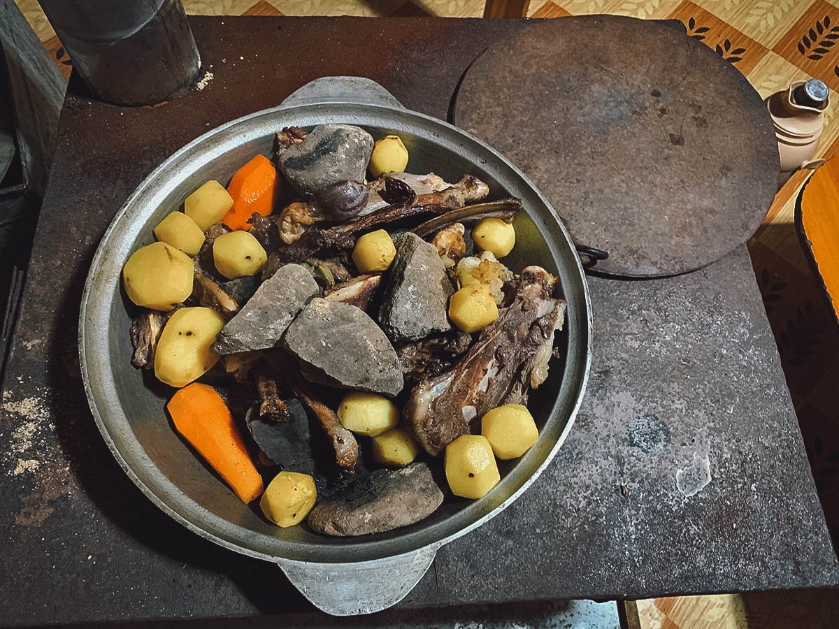 Cooking khorkhog, a traditional Mongolian barbeque