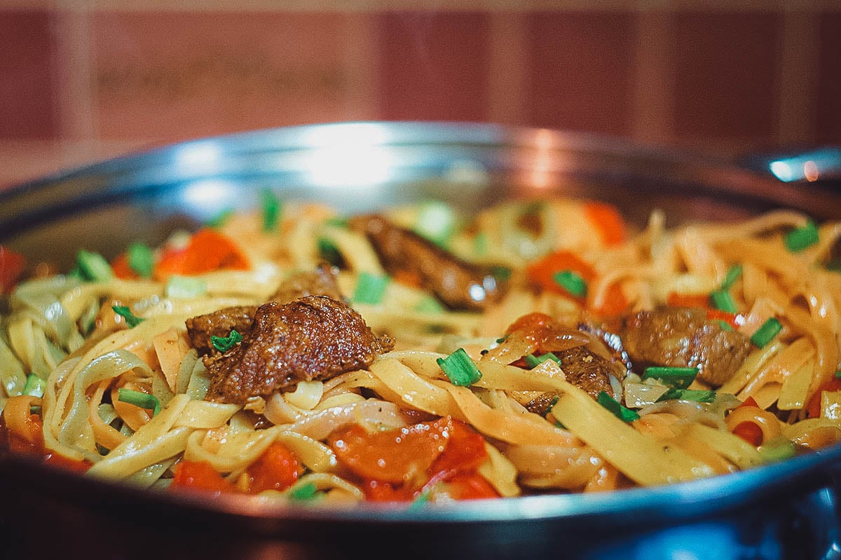 Preparing tsuyvan, a Mongolian dish of meat and fried noodles