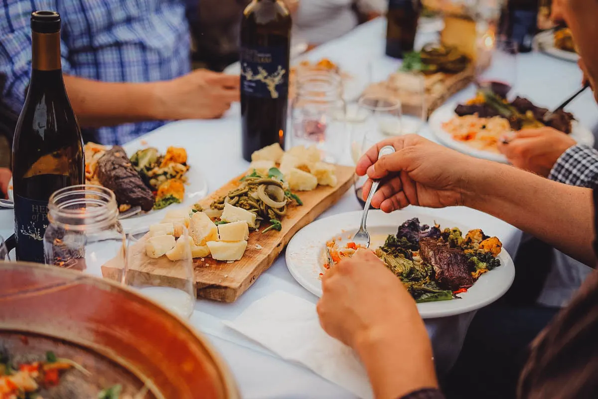 People enjoying a meal with wine