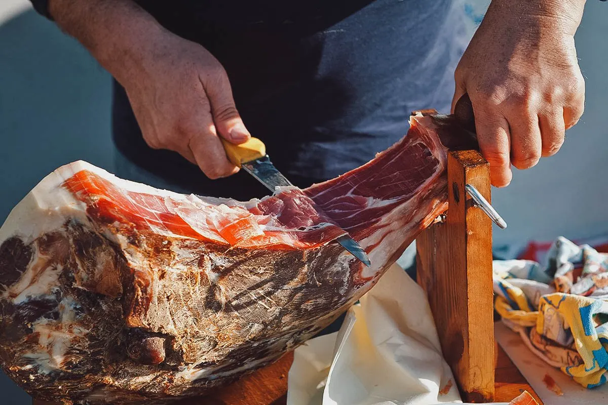 Balkan Food Man slicing prsut
