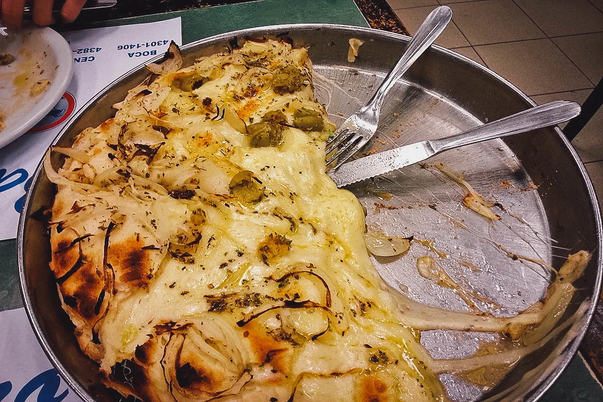 Half-eaten fugazza or Argentine pizza from a restaurant in Buenos Aires