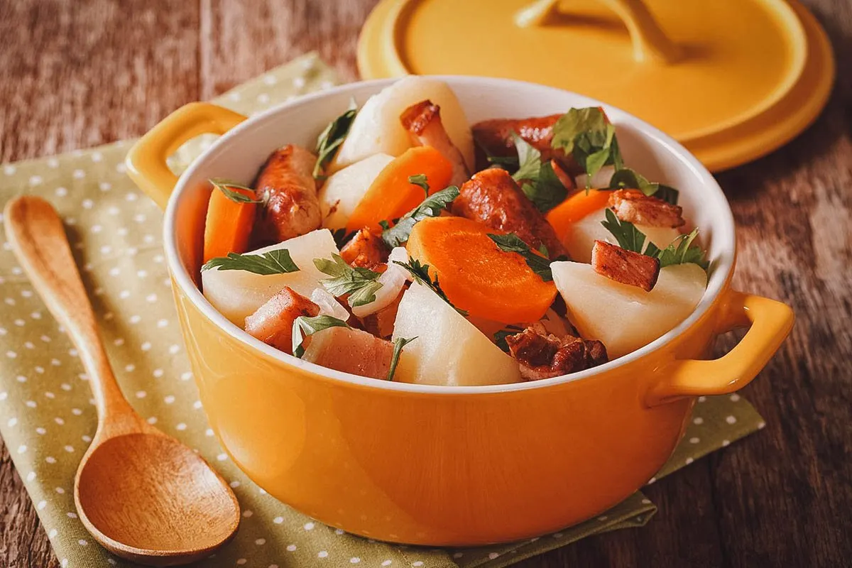 Dublin coddle with pork sausages, rashers, potatoes, and carrots