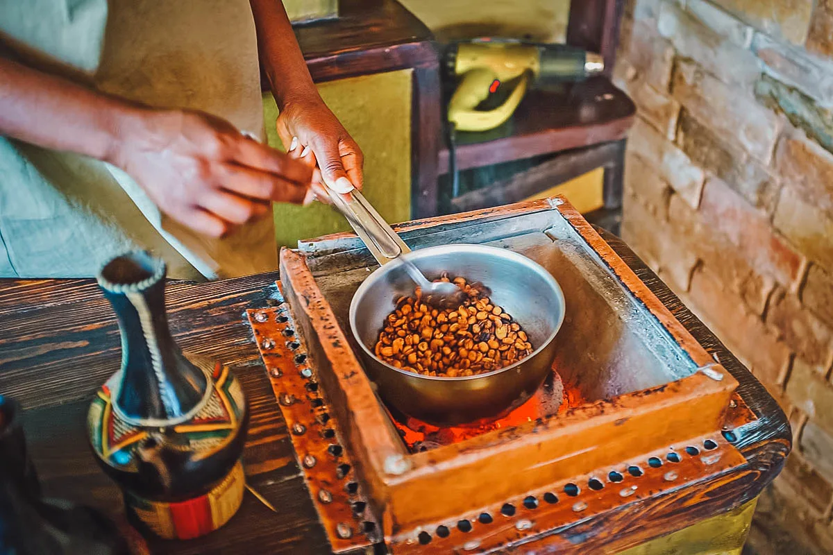 Female coffee maker roasting Ethiopian coffee