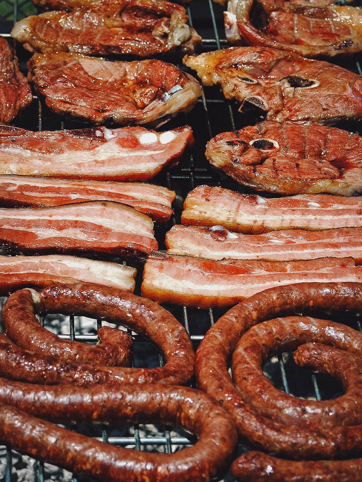 Different meats grilling at a braai or South African barbecue