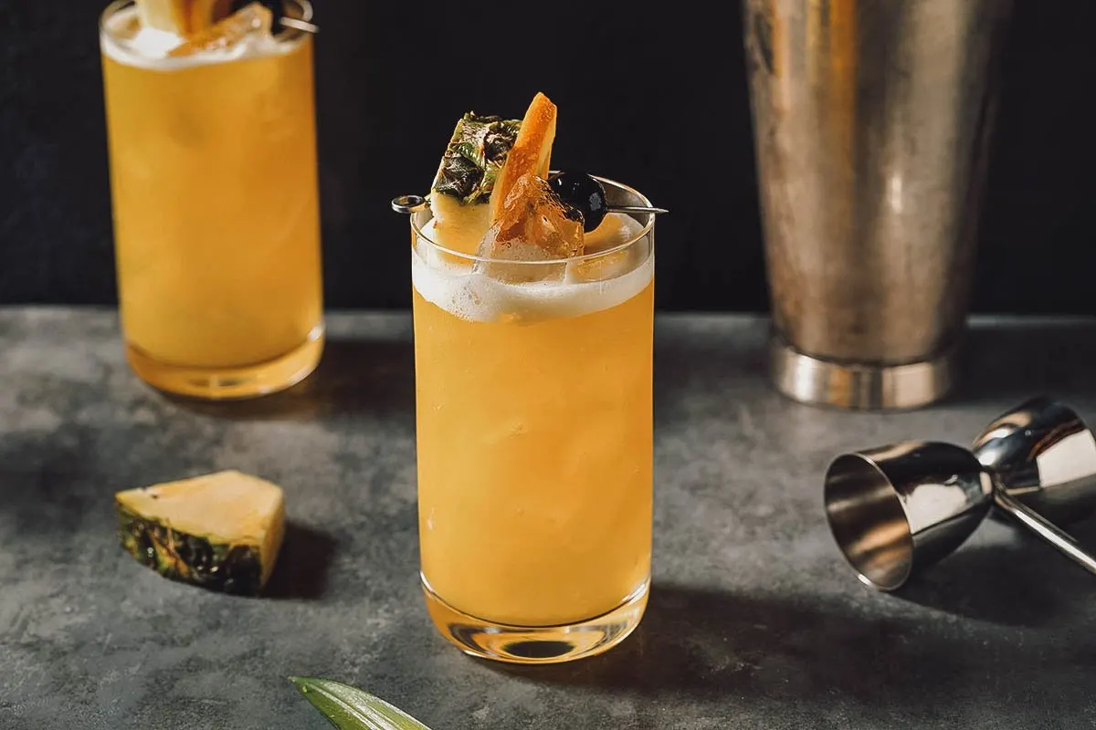 Bahamian Food Yellow Bird, a popular Bahamian cocktail made with dark rum, pineapple juice, and orange juice