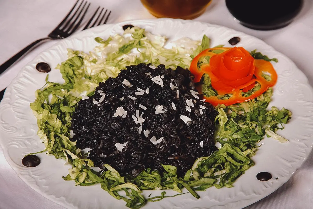 Croatian Food Crni rizot, a Croatian dish of black risotto with squid or cuttlefish