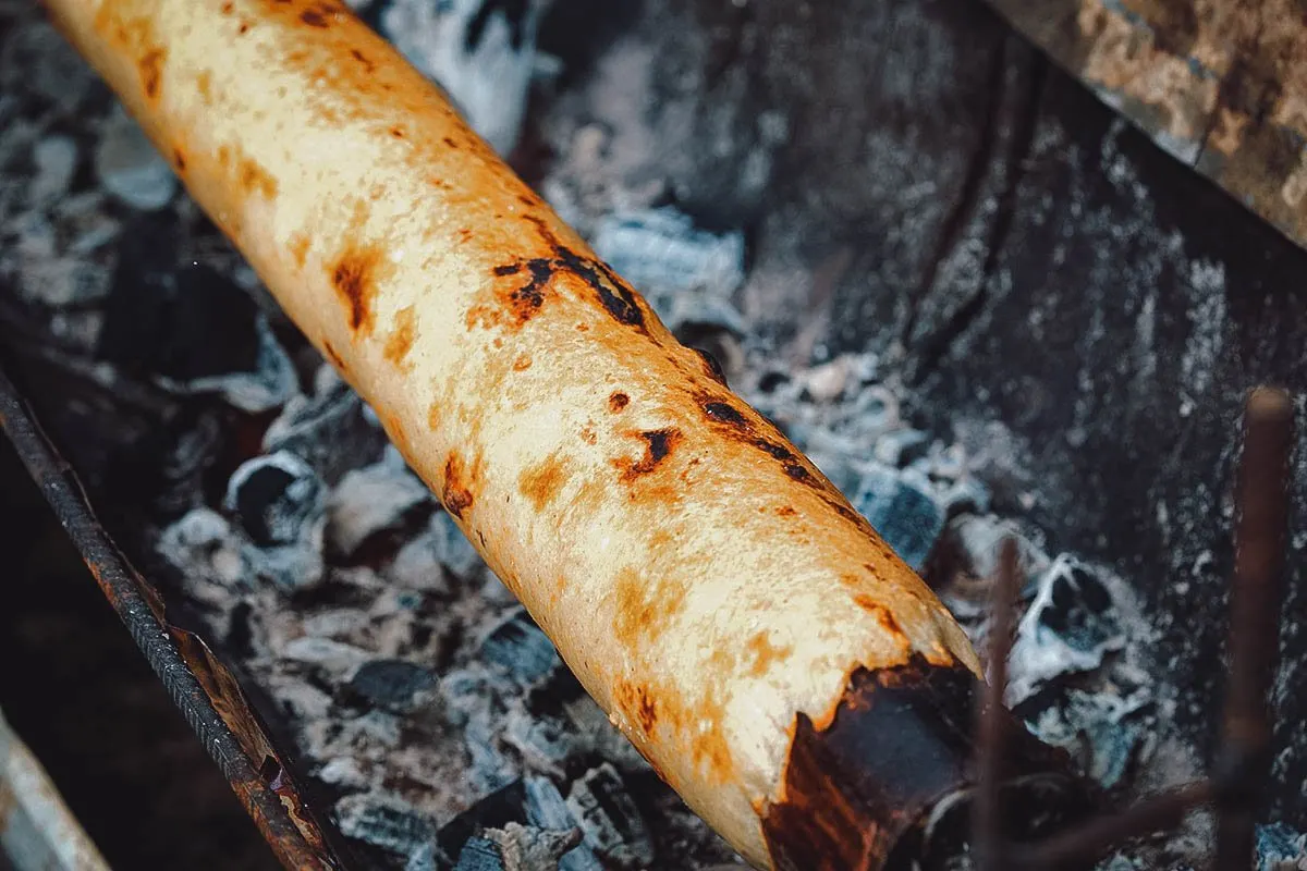 Chochoca roasting on a metal cylinder