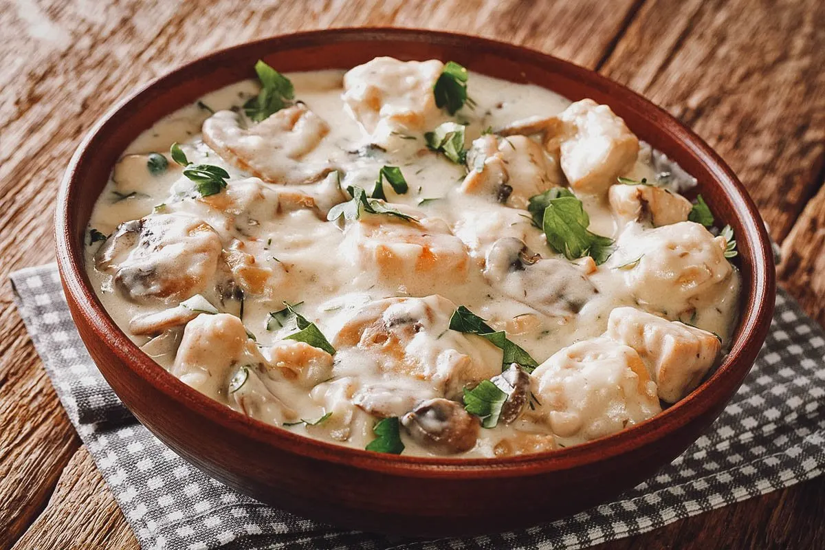 Romanian Food Ciulama, a Romanian dish served in a white roux sauce