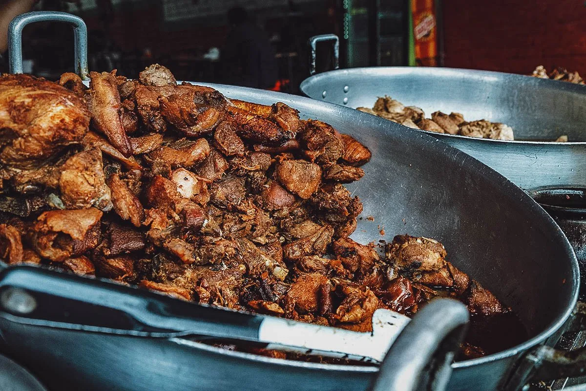 Ecuadorian Food Large batch of fritada de chancho, a traditional food in Ecuador made with braised pork