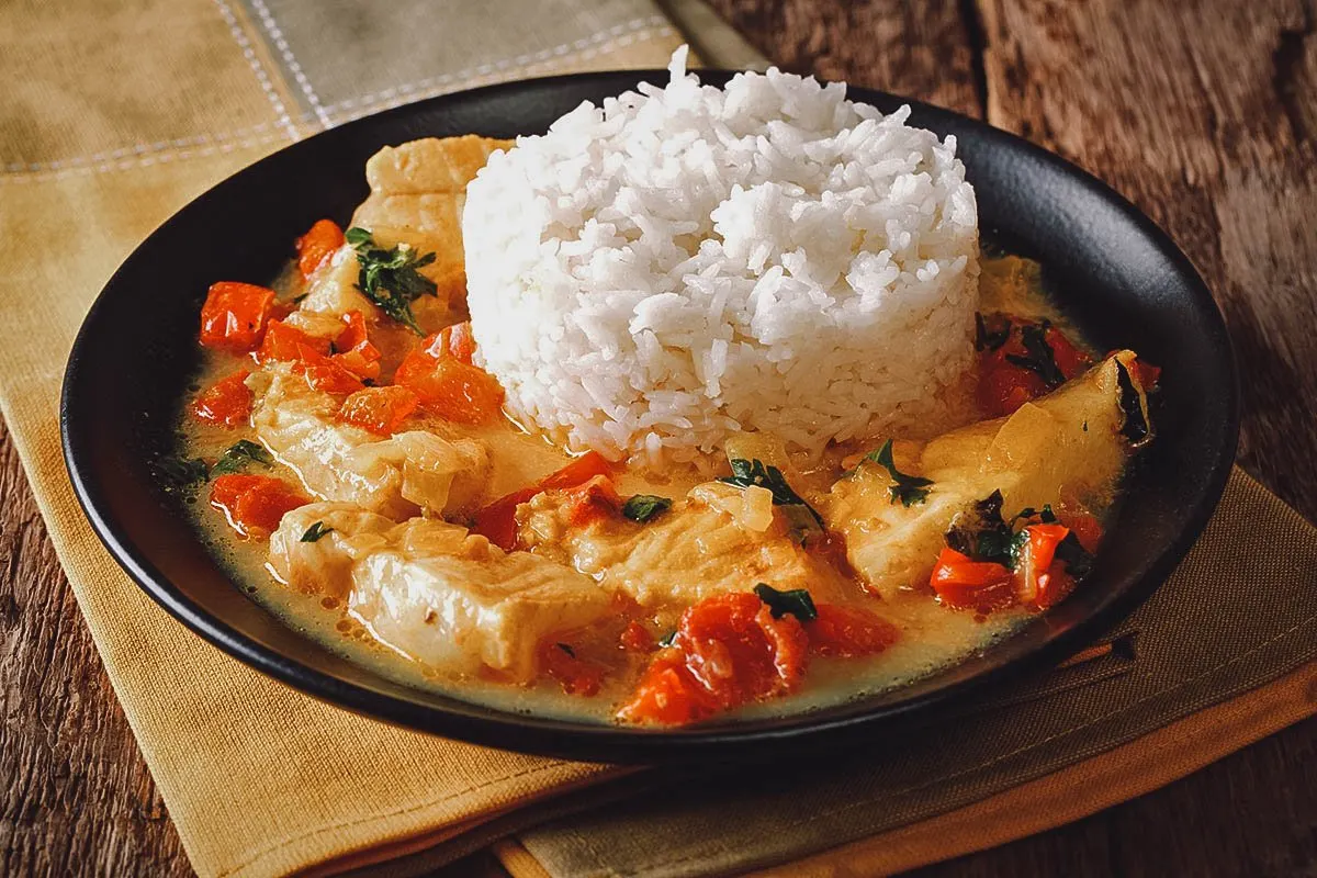 Ecuadorian Food Plate of pescado encocado, an Ecuadorian fish dish made with coconut sauce